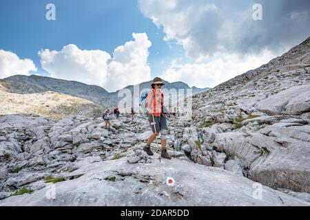 Vier Wanderer in einer Landschaft aus verwaschenen Karstfelsen, Funtenseetauern, Steinernes Meer, Nationalpark Berchtesgaden, Berchtesgadener Land, Obere Stockfoto