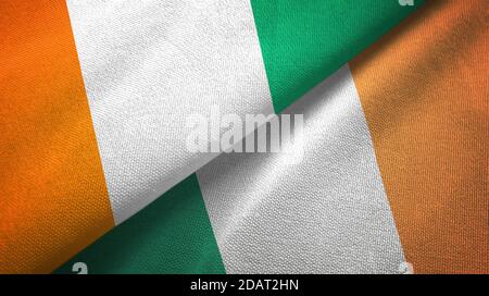 Cote d'Ivoire und Irland zwei Flaggen Textiltuch, Stoff Textur Stockfoto