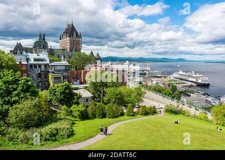 Das schloss frontenac und der St. Lawrence-Fluss mit einem Kreuzfahrtschiff am Hafen in der Stadt Quebec unter stürmischem Himmel zu Beginn des Sommers. Stockfoto