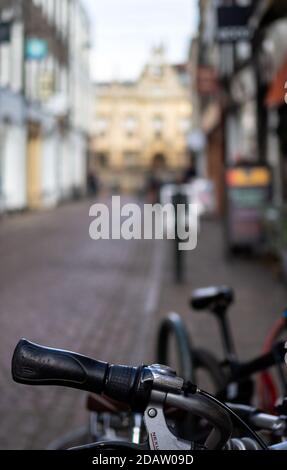 CAMBRIDGE, Großbritannien - 11. MÄRZ 2020: Unschärfe-Blick auf das Stadtzentrum hinter dem Fahrrad Stockfoto
