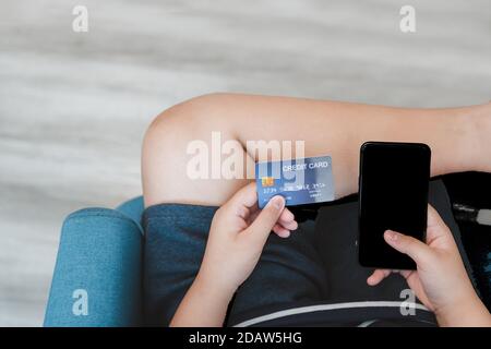 Hand halten Kreditkarte und weißen Bildschirm Handy, Online-Shopping-Konzept Stockfoto