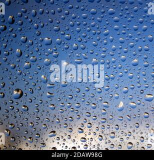 Regentropfen auf das Glas. Abstraktes Hintergrundbild. Natürliches Muster aus nächster Nähe. Selektiver Fokus. Stockfoto