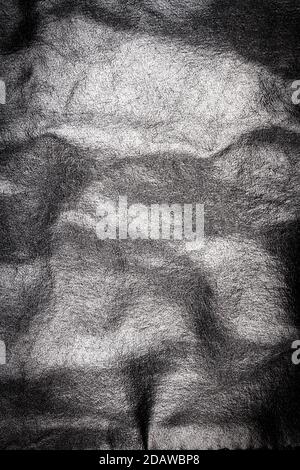 Zerknitterte schwarze Leder Textur Hintergrund. Abstrakte Textur aus Leder. Stockfoto
