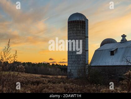 Abendsonne leuchtet Bauernhof Silos und Scheune in ländlichen Vermont Stockfoto