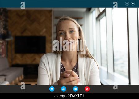 Lächelnd junge blonde 30s Frau reden Blick auf Web-Kamera. Stockfoto