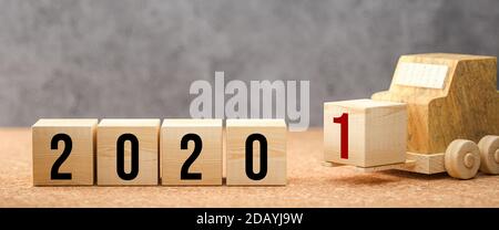 Würfel mit der Nummer 2020 und dem Gabelstapler, der die 1 liefert Für 2021 auf konkretem Hintergrund - 3d-Illustration Stockfoto