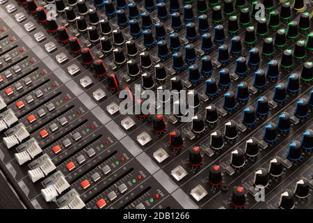 Buttons and knobs to adjust a mixer for music and sound processing Stockfoto