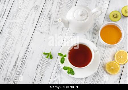 Tasse schwarzen Tee mit Honig und Zitrone auf Holzgrund: Draufsicht Stockfoto