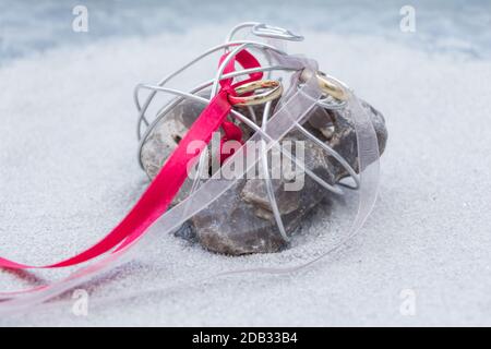 Feier Symbol für Zweisamkeit, Einheit, Liebe. Schöner Ring für Braut und Bräutigam warten auf Gelübde auf Dekoration Stein in Riemen. Stockfoto