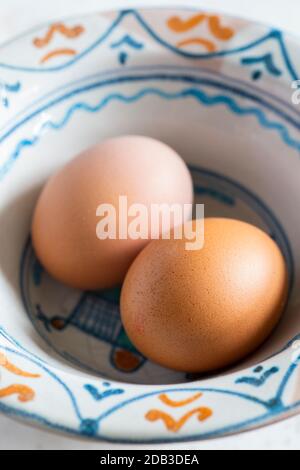 Schüssel mit frisch gekochten Eiern in einer gemusterten Steingutschüssel - FOODPIX Stockfoto