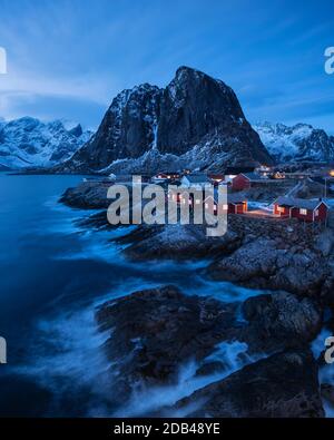 Traditionelle rote Rorbu Fischerhütten an der felsigen Küste von Hamnøy, Lofoten Inseln, Norwegen Stockfoto
