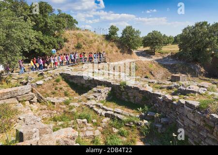 Troja, Provinz Çanakkale, Türkei. Reiseleiter erklärt den Besuchern die Ruinen. Troja ist ein UNESCO-Weltkulturerbe. Stockfoto