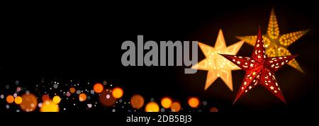Leuchtende rote und goldene Weihnachtsstern Laternen Rahmen einen einfachen, extra breiten schwarzen Hintergrund als Kopierraum Stockfoto