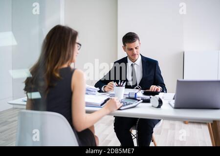 In der Nähe von zwei Geschäftsleute, die Berechnung des finanziellen Erklärung am Schreibtisch Stockfoto