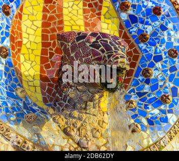 Medaillon mit Kopfschlange im Parc Güell entworfen von Antoni Gaudi auf dem Carmel Hügel, Barcelona, Spanien. Stockfoto