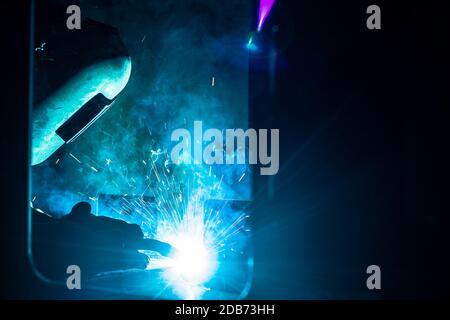 Schweißgerät arbeiten im Werk mit vielen Funken fliegen Stockfoto