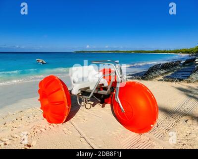 Bunte Segelboote und Motorboot, an einem tropischen Strand bei Half Moon Cay auf den Bahamas an einem tropischen Strand bei Half Moon Cay auf den Bahamas Stockfoto