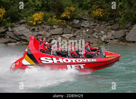 Touristen genießen ihre Fahrt auf der Shotover Jetbootfahrt auf dem Shotover River in der Nähe von Queenstown auf Neuseelands Südinsel. Stockfoto
