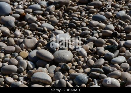 Große, kleine, runde Steine am Mittelmeer in der Provinz Alicante, Spanien Stockfoto