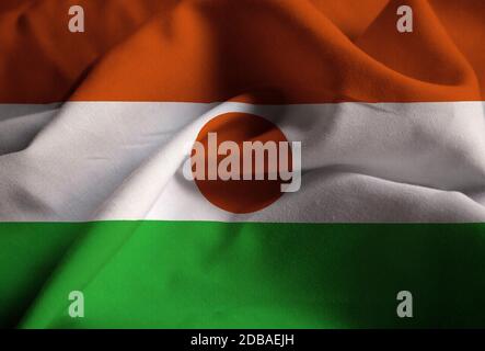 Nahaufnahme der Flagge von Ruffled Niger, Niger Flagge weht im Wind Stockfoto