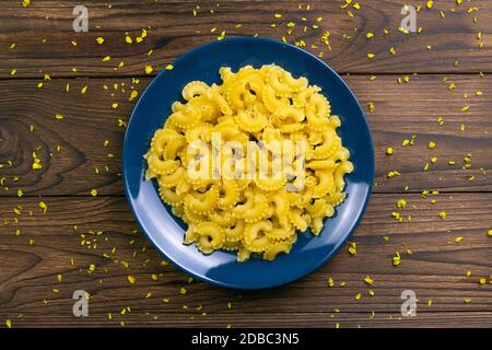 Pene Lisce Pasta in blauer Platte auf dunklem Holzhintergrund. Tolle Aussicht. Stockfoto