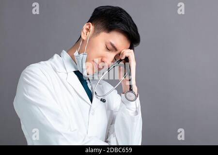 Stress und müde junge Ärzte tragen medizinische Maske Stockfoto