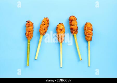 Gegrilltes Hackhuhn mit Currypaste und Kokosnusscreme auf den Spießen aus Zitronengras. Draufsicht Stockfoto