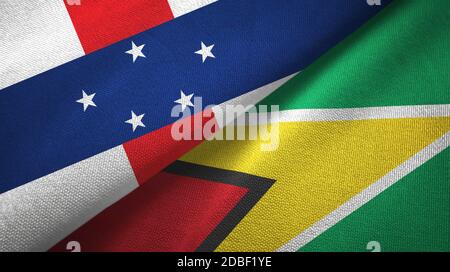 Niederländische Antillen und Guyana zwei Flaggen Textiltuch, Stoff Textur Stockfoto