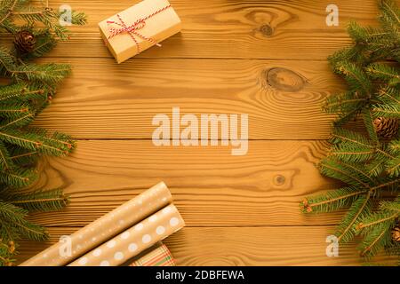 Weihnachten Zero Waste, umweltfreundliche Verpackung. Festliche Weihnachtskomposition verpackt Geschenke in Kraftpapier auf einem Holztisch.Copy space Stockfoto