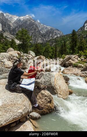 Wanderer Wanderer lesen eine Wanderkarte auf Wanderung im Himalaya-Gebirge. Himachal Pradesh, Indien Stockfoto