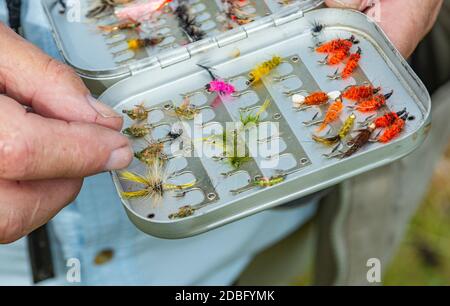 Halten Sie eine Kiste mit Fischen Fliegen oder Köder für Fliegenfischen verwendet, Nahaufnahme Stockfoto