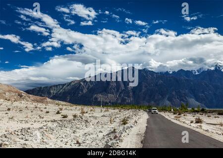 Asphaltierte Straße im Himalaya mit Autos. Nubra Tal, Ladakh, Indien Stockfoto