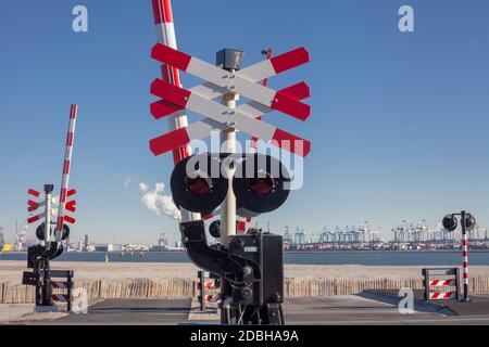 Hafen von Rotterdam. Schilder am Bahnübergang mit einer Barriere. Organisation des Verkehrssystems eines europäischen Landes. Sicherheit des Verkehrs in Stockfoto