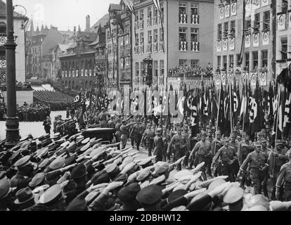 Adolf Hitler (im Mercedes stehend) begrüßt die Formationen der SA und der politischen Organisationen auf dem Nürnberger Hauptmarkt. Vor ihm stehen Viktor Lutze und Rudolf Hess. Hinter ihnen ist Heinrich Hoffmann mit einer Fotokamera. Stockfoto