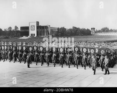 Blick auf die Parade der Standards von SA, SS und NSKK zur Totenehrung in der Luitpoldarena während des NSDAP-Kongresses in Nürnberg. Im Hintergrund links ist die Luitpoldhalle mit Hakenkreuzfahnen geschmückt. Stockfoto