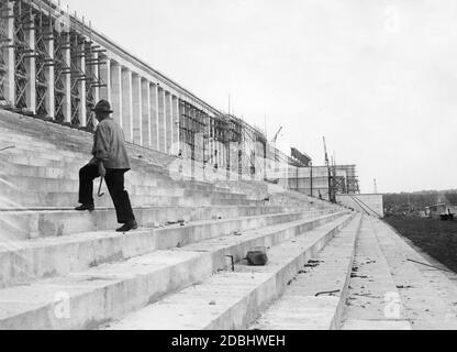 Auf dem Zeppelin-Feld des Reichsparteitagsgeländes in Nürnberg geht ein Mann die Stufen der derzeit im Bau befindlichen Tribüne hinauf. Stockfoto