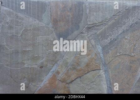 Abstrakte Textur der alten Steinwand des Straßenhauses ordentlich gestapelt rau geschnitten Steinwand nahtlose Textur Hintergrund. Stockfoto