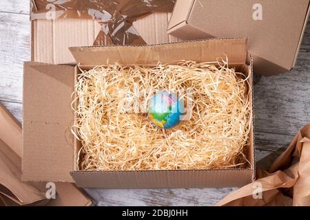 Globe in box on the wood shavings filler. Stock Photo