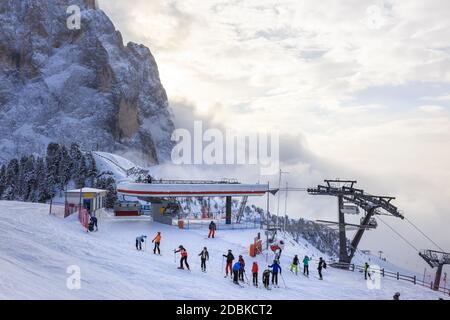 Skilift und Skifahrer auf der Piste mit Teilblick auf den Langkofel dahinter, am Abend, Gröden, Dolomiten, Italien Stockfoto