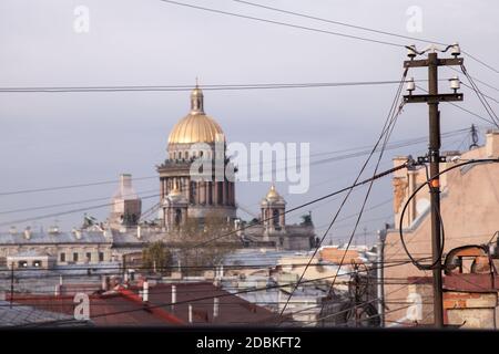 Drähte und Dächer von St. Petersburg, Russland. St. Isaac Kathedrale Kuppel ist auf einem Hintergrund Stockfoto