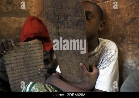 Die Kinder der koranschule sitzen Stunde für Stunde und Tag für Tag vor Holztafeln und rezitieren koranverse in Timbuktu, Mali, Afrika. Stockfoto