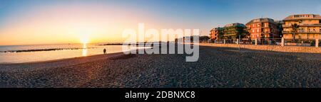 Rom, Italien - 06. November 2020:Blick auf die Küste und die Promenade von Rom in Ostia Lido bei Sonnenuntergang mit Spaziergängen und genießen Sie den schönen Winter d Stockfoto