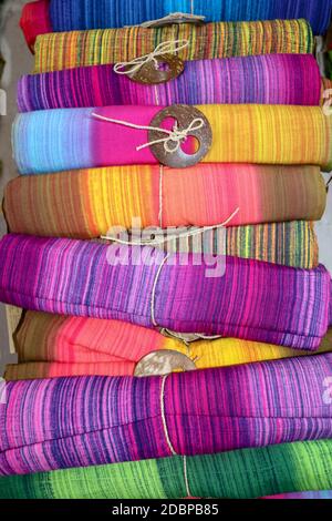 Batik Tuch Tuch zum Verkauf gerollt auf dem Markt. Balinesische Kunst und Kultur. Nahaufnahme von gerolltem farbenfrohem Sarong. Bunte Stoffrollen. Traditionell Hindu Stockfoto