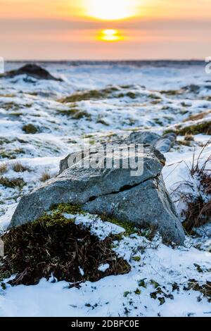 Sonnenuntergang über einer kalten, gefrorenen Winterlandschaft auf Hochmooren Stockfoto