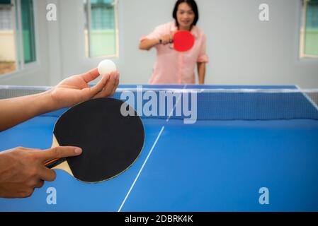 Erwachsene asiatische Frau warten darauf, Tischtennis oder Tischtennis spielen zu beginnen. Freizeit mit dem Wettbewerb in Sportspielen im Haus, Erholung oder ex Stockfoto