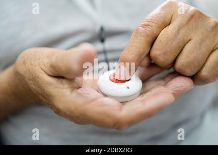 Nahaufnahme des leitenden Mannes, der die Alarmtaste für den Notfall drückt Stockfoto