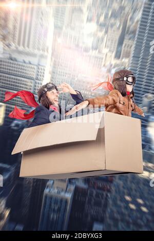 Mann und Kind spielen fliegen in einer weißen Karton-Box Stockfoto