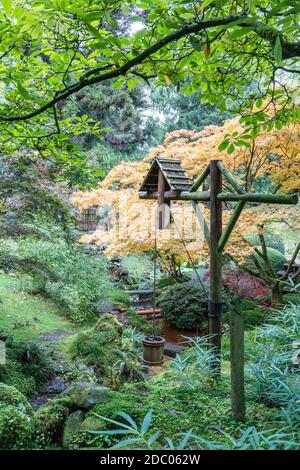 Malerische Ecke des Japanischen Gartens mit altem Holzeimer und Wasserhebel im Tatton Park, England. Stockfoto