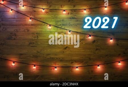 2021 glückliches neues Jahr Hintergrund. Neon-Nummern 2021 und Girlanden mit Lichtern auf Holzgrund. Copyspace. Stockfoto