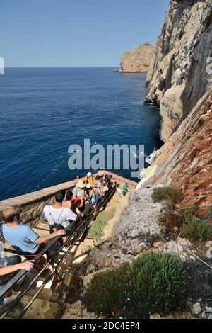 Die Leute steigen die Treppe hinunter, die zur Neptun-Grotte führt, in der Nähe von Alghero auf Sardinien Stockfoto